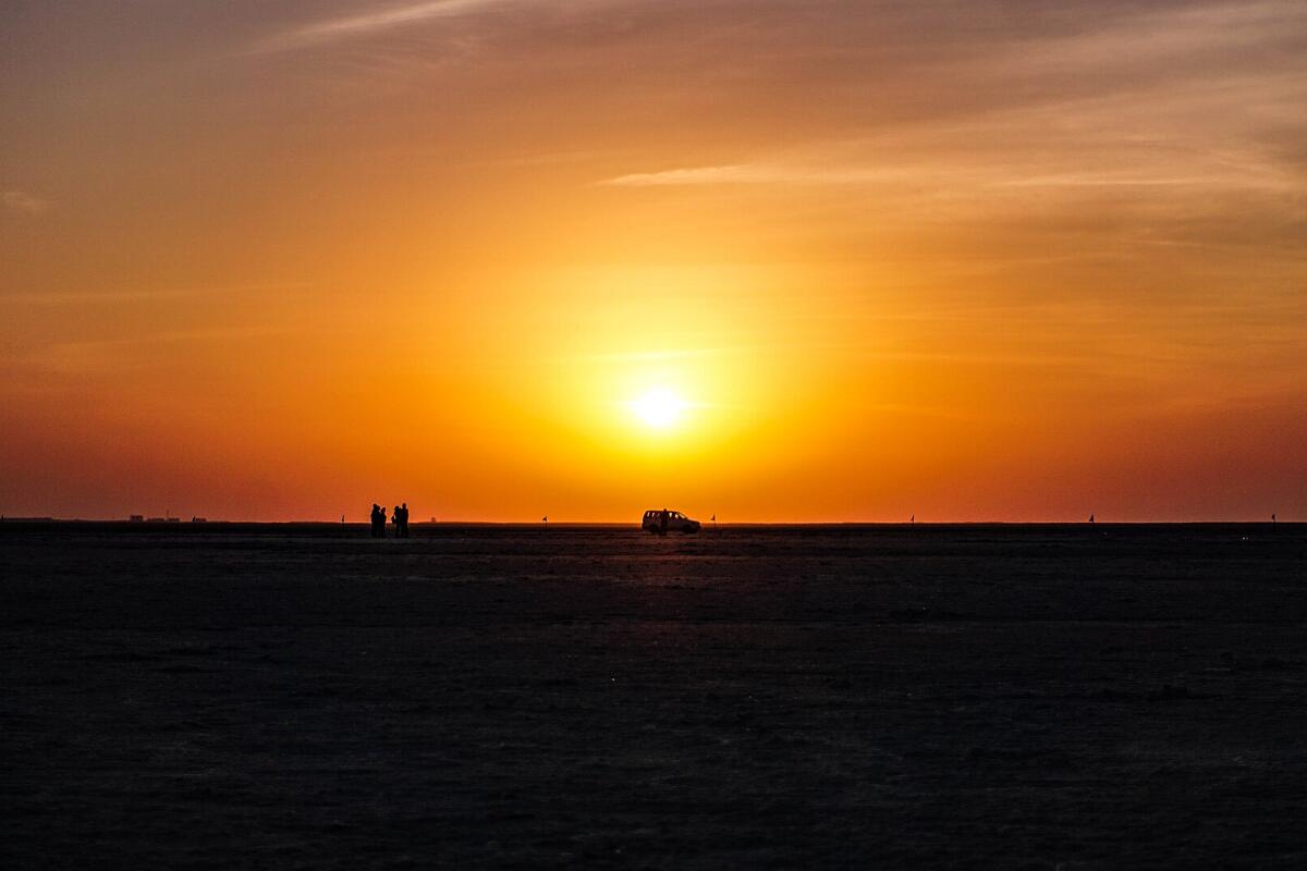 The sun setting over the flat salt desert of the Rann of Kutch at Dhordo