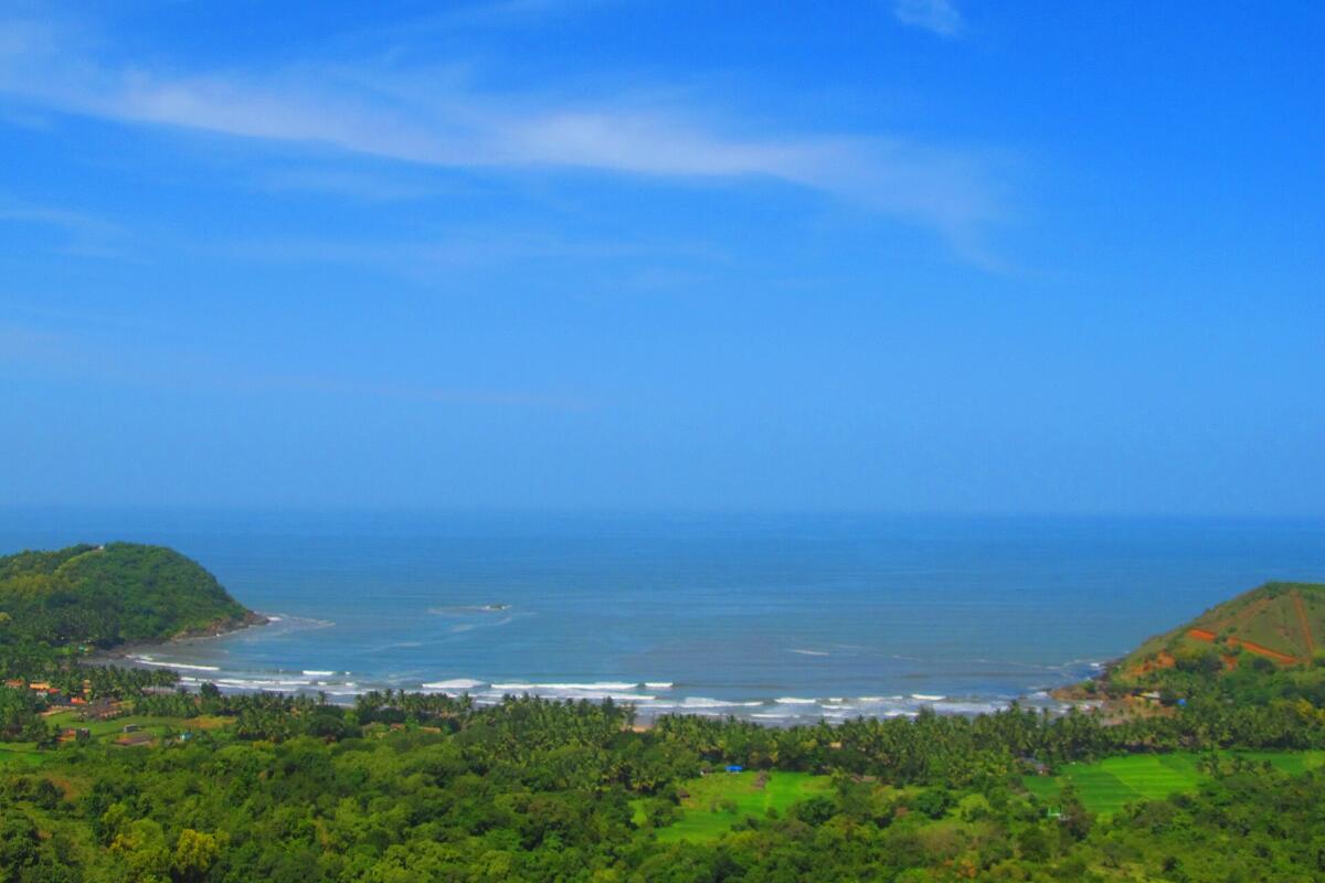 A blue bay at Gokarna seen from the green hills above it