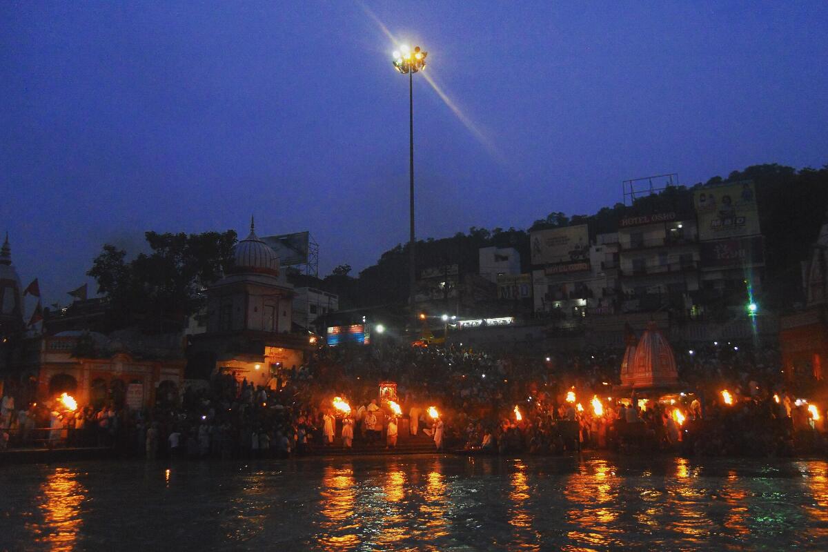The ghats of Haridwar glowing with lights along the Ganga at dusk