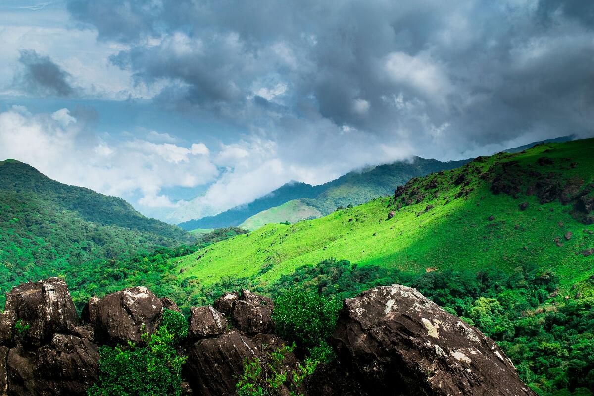 Green hills and valleys of Coorg under a cloudy sky