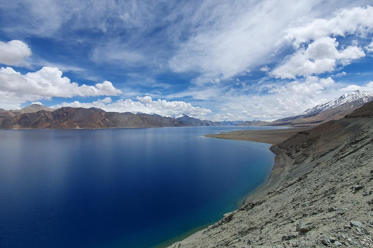 The deep blue water of Pangong Tso in Ladakh between bare brown mountains